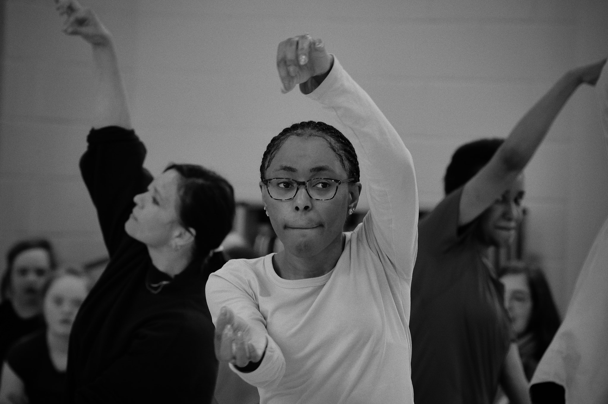 Black and white photo of Nicole dancing at Professional Development Class sharing 